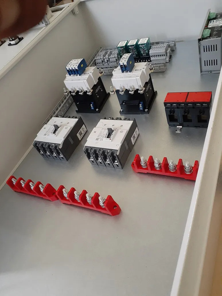 Indian engineer assembling an electrical control panel at Akshayam Controls & Automation, a leading Electrical Panel Manufacturer in Coimbatore.
